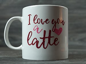 The finished mug reading "I love you a latte" made in Red and Rainbow Red Pressure Sensitive GlitterFlex Ultra
