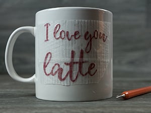 The Pressure Sensitive GlitterFlex Ultra being placed onto the mug