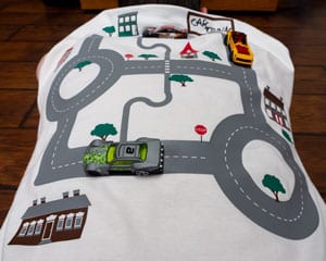The finished shirt with a car on the back showing how the shirt can be used