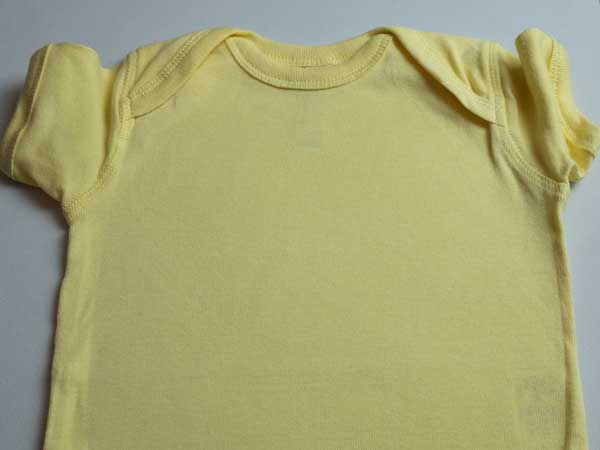 The onesie before pressing with no wrinkles on the area of pressing