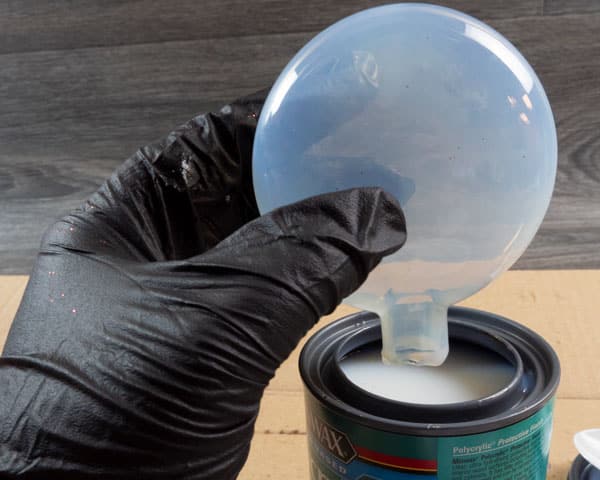 Letting the excess polycrylic drain back into the polycrylic container