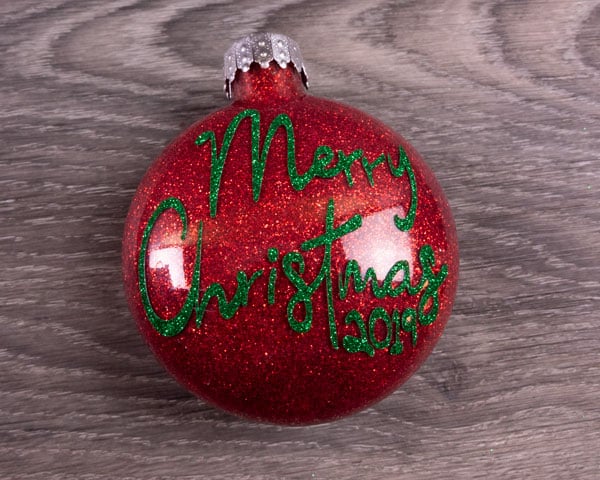 A finished ornament with red glitter on the inside and Pressure Sensitive GlitterFlex® Ultra