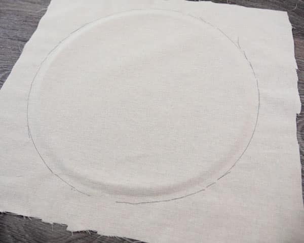 The cloth after being measured for where we need to cut- the hoop was used to sketch an outline