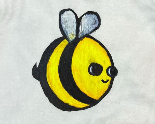 A bee painted onto ThermoFlex® Color Up and pressed onto a shirt